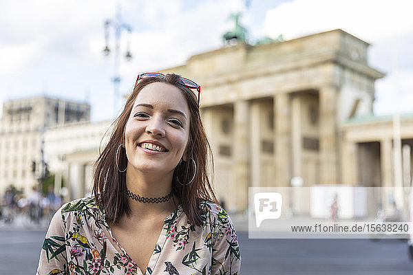 Portrait of smiling young woman in front of Brandenburger Tor  Berlin  Germany