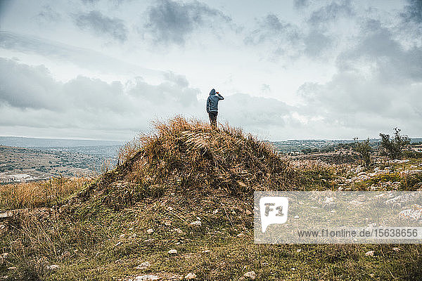 Young man standing on a hill during storm  Sicily