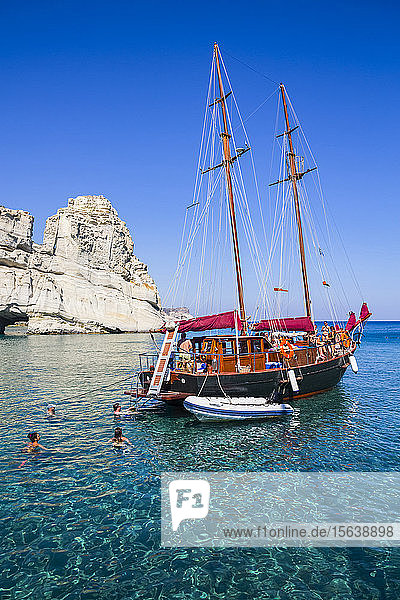 Tourists with tour boat in Kleftiko Bay; Milos Island Cyclades Greece