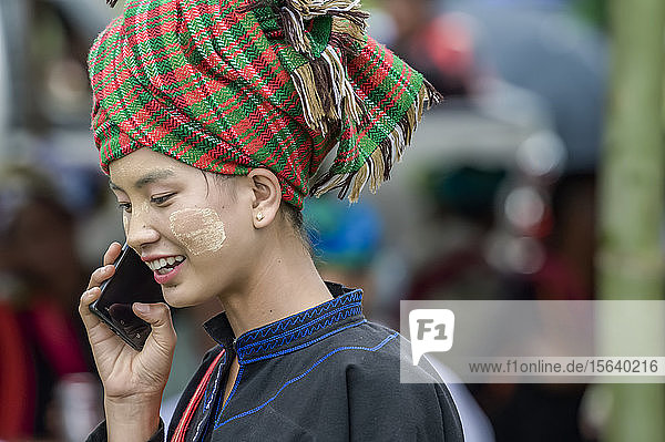 Modern Burmese young woman on smart phone; Yawngshwe  Shan State  Myanmar