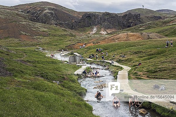 People bathing in the hot thermal springs Reykjadalur  geothermal area  near Hveragerdi  southern Iceland  Iceland  Europe