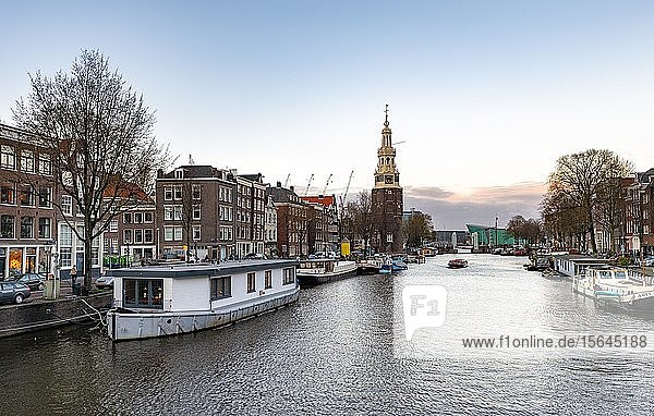 Old tower  Montelbaanstoren  Oudeschans  canal with boats  Amsterdam  North Holland  Netherlands