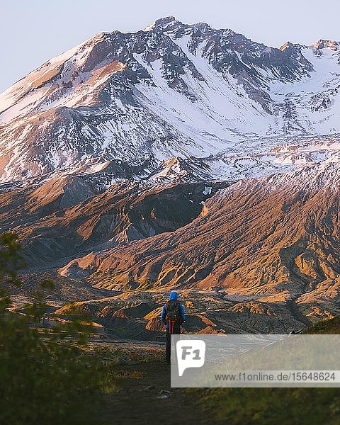 Hiker admiring Mount St Helens National Monument from afar  Washington  USA
