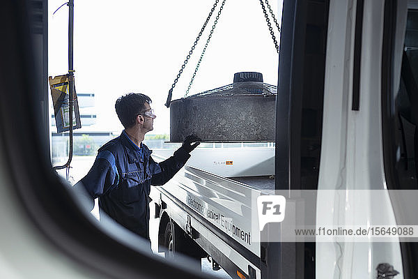 Engineer loading parts into truck in electrical engineering factory