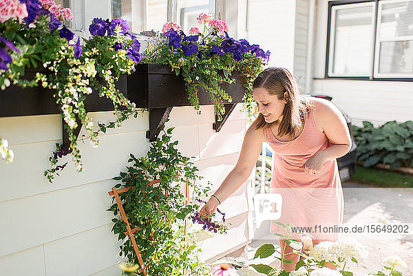Woman tending to flowers in garden
