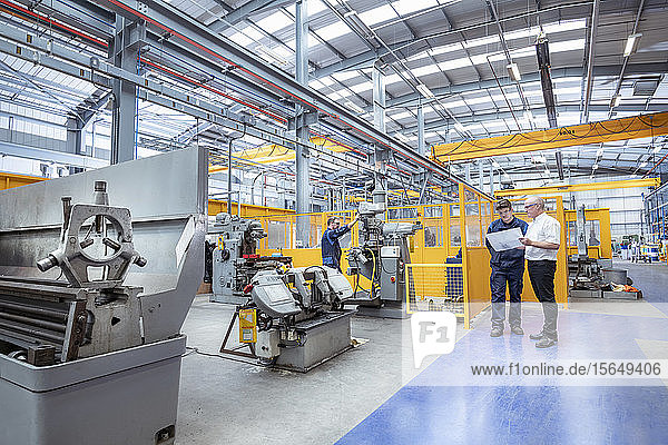 Manager and engineers in electrical engineering factory