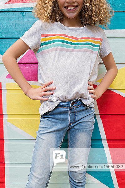 Girl in front of colorful wall