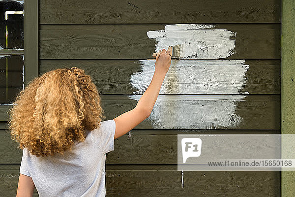 Girl painting house