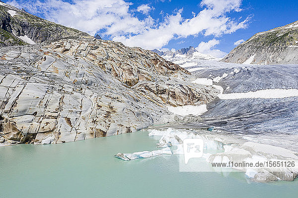 Rhone Glacier and glacial lake at its base in summer aerial view Gletsch Canton of Valais Switzerland