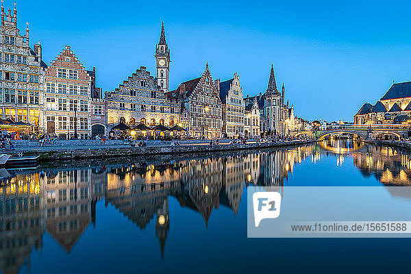 Graslei Quay in the historic city center of Ghent  mirrored in the River Lys during blue hour  Ghent  Belgium