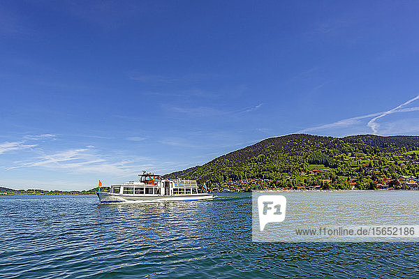 Ferry on Lake Tegernsee against blue sky during sunny day,  Bavaria,  Germany