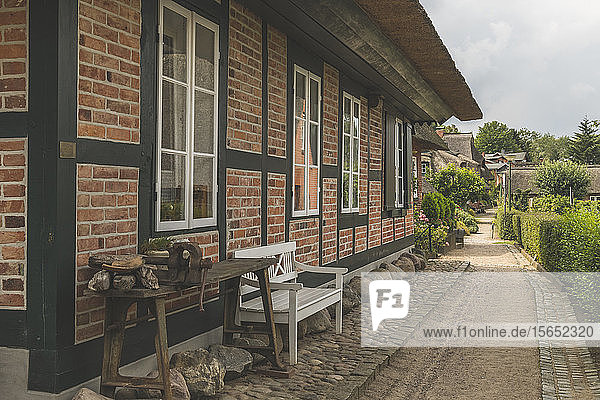 Footpath by houses in Gothmund village Lübeck Germany