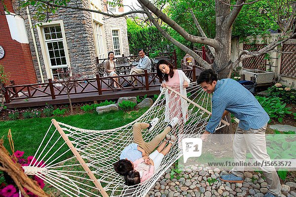 Happy family playing in the courtyard