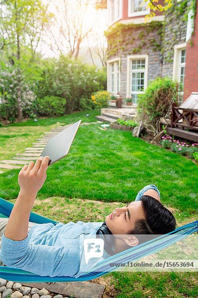 Young men see the tablet in the yard