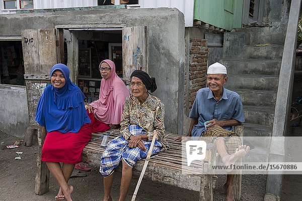 A village scene with local people in the Bajau Sea Gypsy village on Bungin Island  famous for living in stilt houses above the water and living entirely off the sea  off the coast of Sumbawa Island  Indonesia.