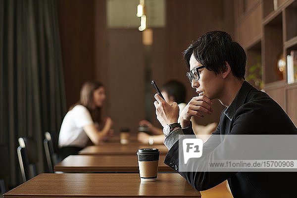 Young Japanese businessman at a cafe