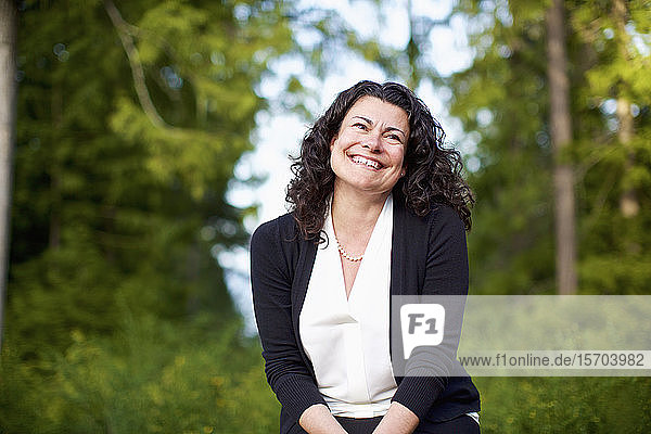 Portrait confident  happy woman smiling in woods