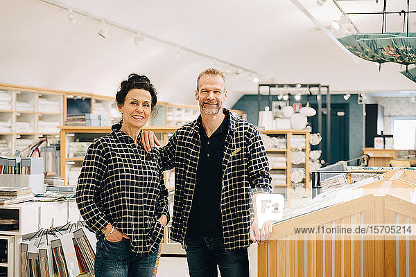 Portrait of smiling coworkers standing in store