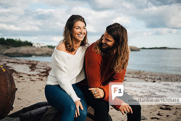 Smiling couple spending leisure time at beach