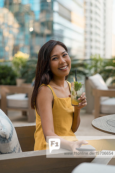 Portrait of happy woman sitting in a cafe with a drink