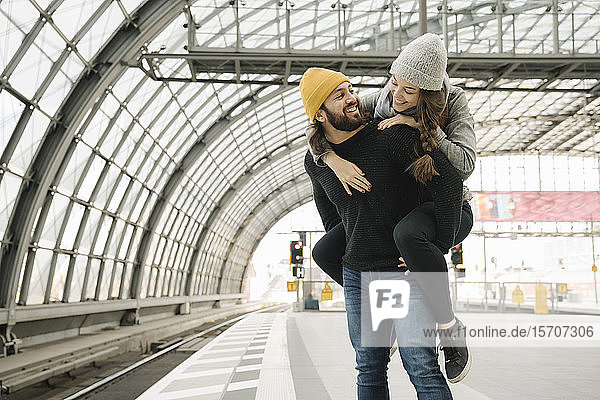 Happy young couple having fun at the station platform  Berlin  Germany