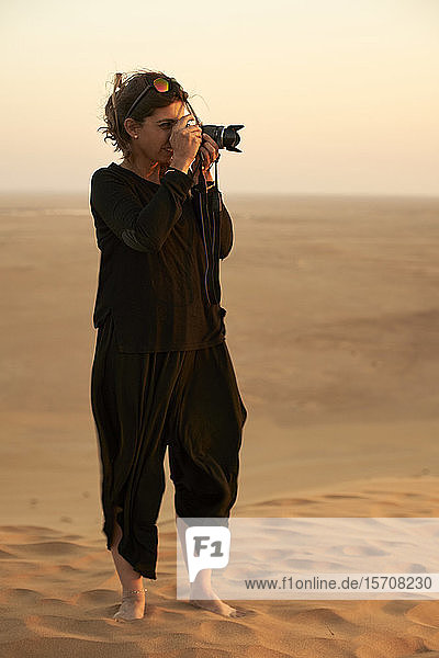 Frau beim Fotografieren in der Wüste  Düne 7  Walvis Bay  Namibia