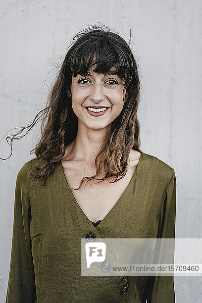 Portrait of smiling brunette woman looking at camera