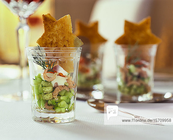 Shot glass appetizer with cucumbers and star-shaped crab meat