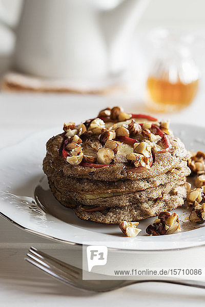 Plate of gluten free buckwheat pancakes with banana  apple and nuts