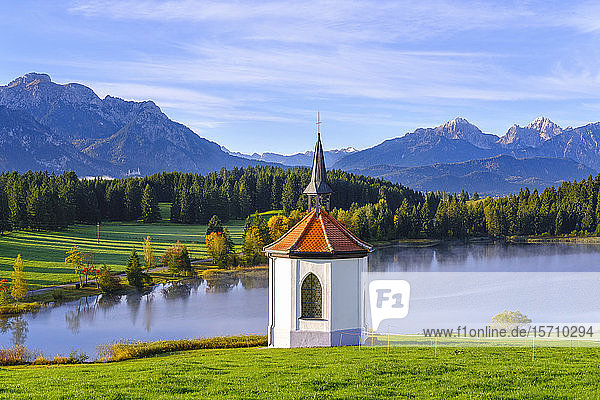 Germany  Bavaria  Halblech  Chapel against Hegratsrieder See lake in Tannheim Mountains