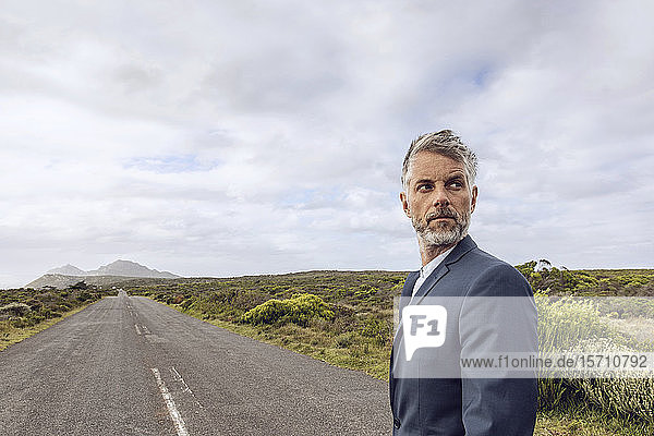 Portrait of businessman standing on country road  Cape Point  Western Cape  South Africa