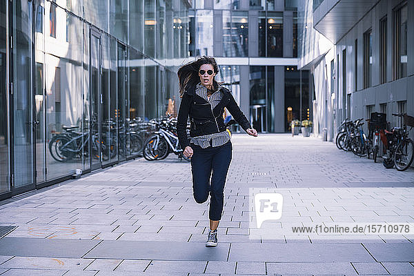Woman with sunglasses running away