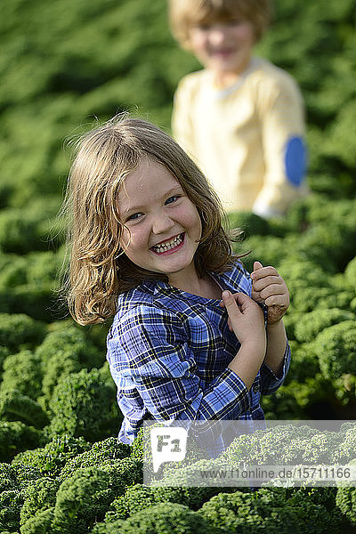 Smiling girl and boy in a kali field