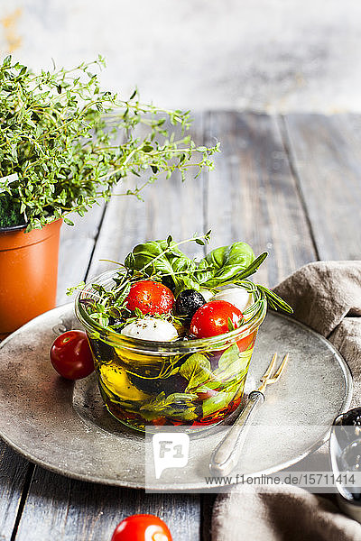 Jar of fresh Caprese salad preserved in olive oil