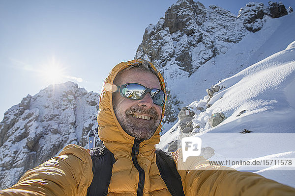 Selfie of a happy mountaineer on snowy mountain  Lecco  Italy