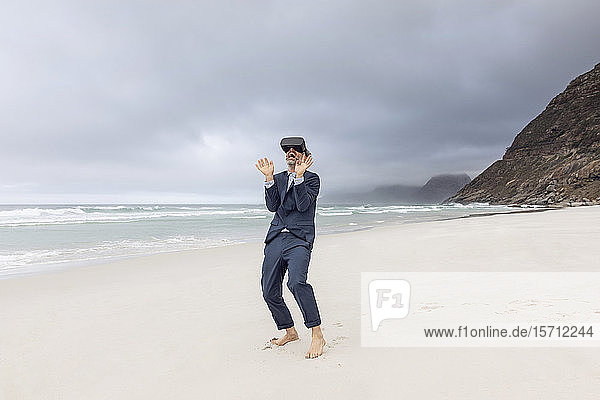 Businessman using VR glasses on the beach  Nordhoek  Western Cape  South Africa