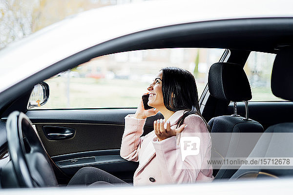 Businesswoman using smartphone in the car