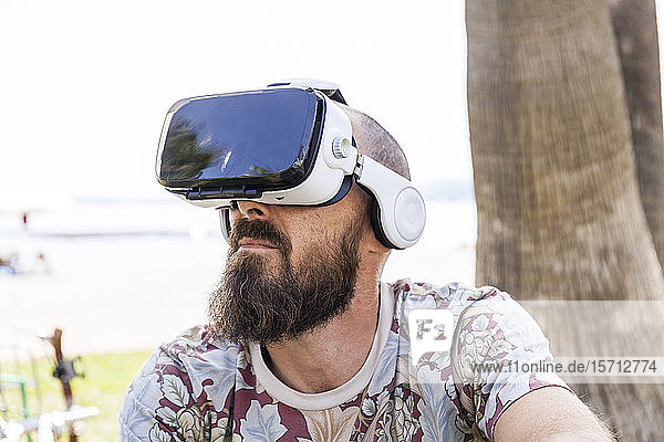 Mature man with virtual reality glasses