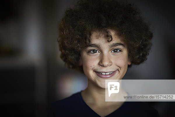 Portrait of smiling boy with brown ringlets