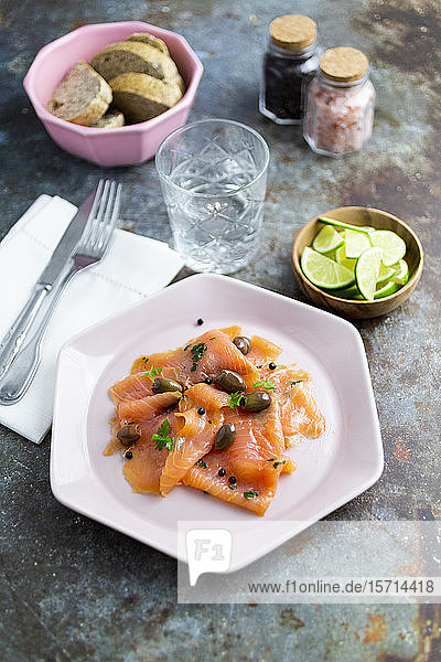 Raw salmon meat with lime  olives and herbs