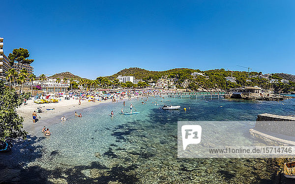 Spain Mallorca Camp de Mar Large group of people relaxing along coastal beach in summer