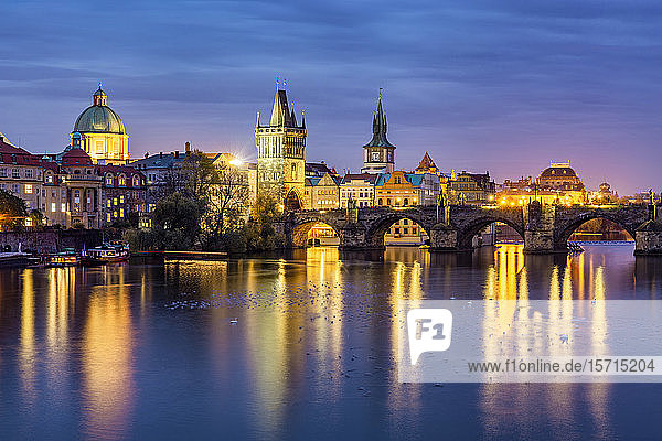 Tschechische Republik  Prag  Vögel schwimmen in der Dämmerung in der Moldau mit der Karlsbrücke und der Altstadt von Prag im Hintergrund