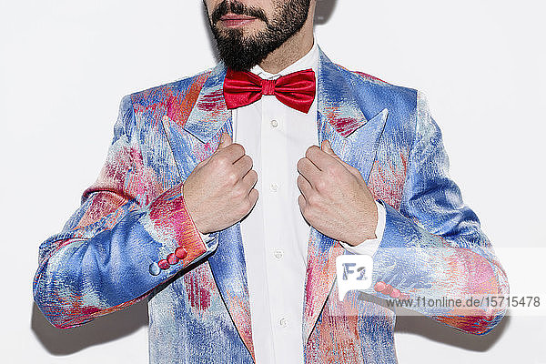Stylish man wearing a colorful suit and a red bow tie