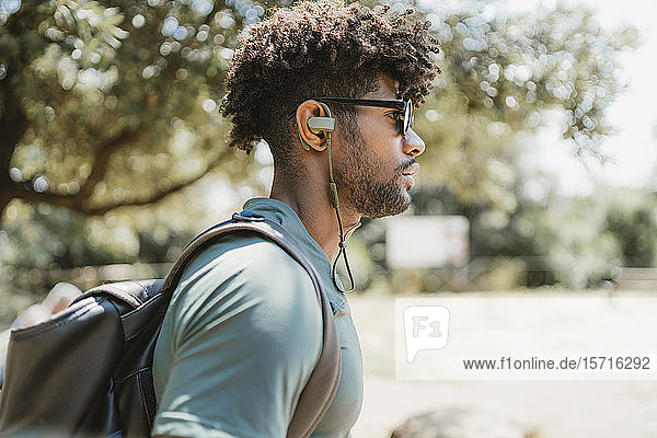 Young man with earphones in a park