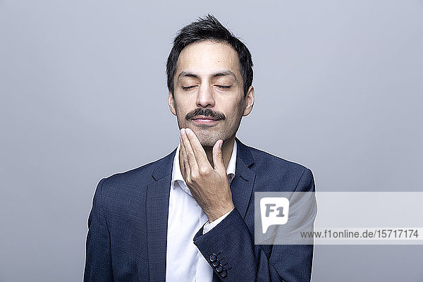 Portrait of content businessman with eyes closed