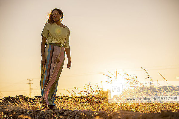 Beautiful woman taking a walk at sunset  Mykonos  Greece
