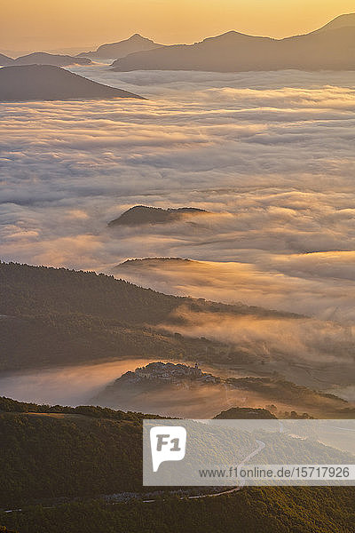 Italy  Aerial view of thick morning fog shrouding forested valley in Apennine Mountains