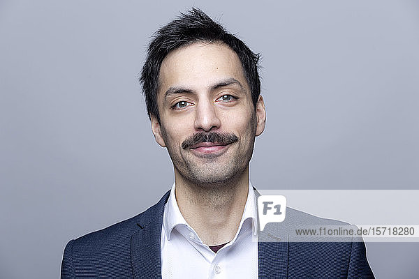 Portrait of smiling businessman with moustache