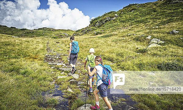 Mother with two children hiking in alpine scenery  Passeier Valley  South Tyrol  Italy