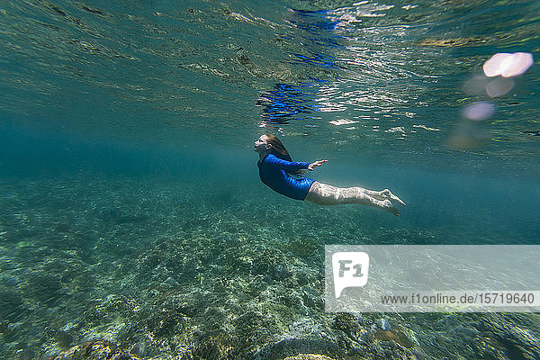 Indonesia Bali Young woman snorkeling in Nusa Penida island